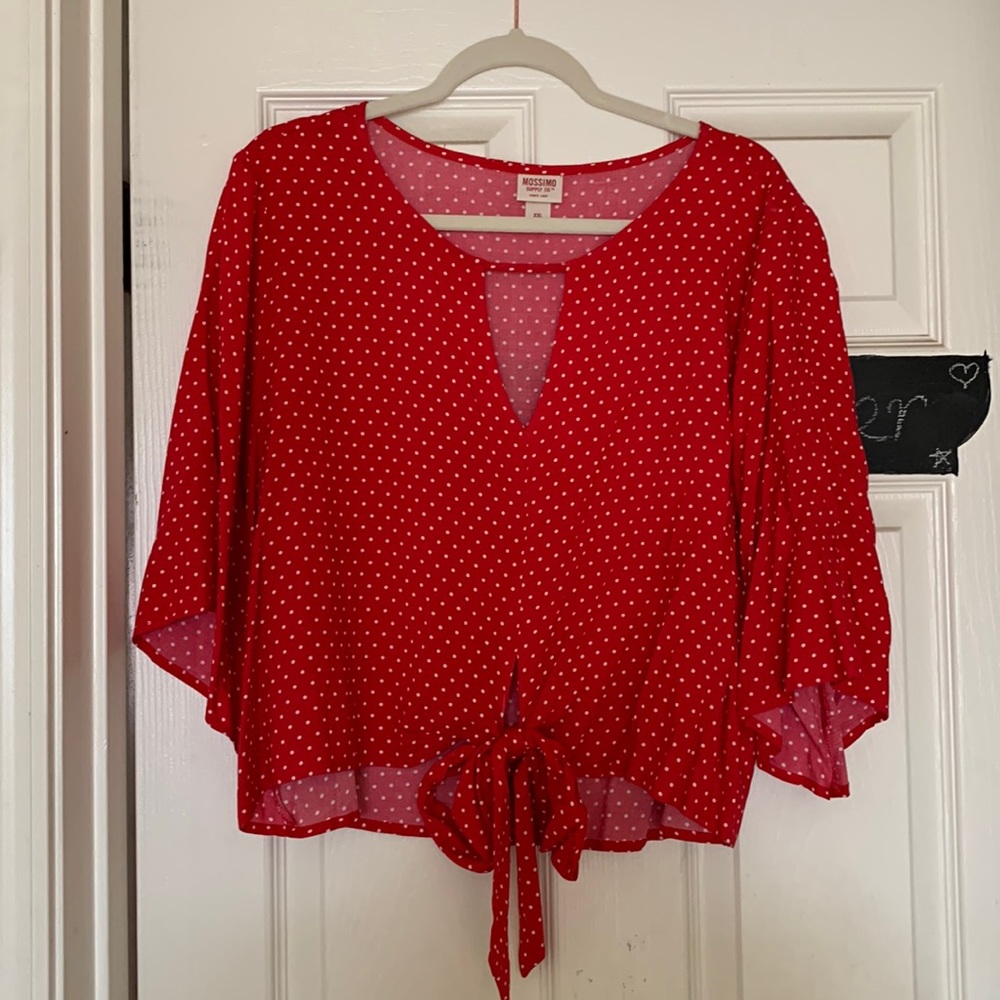 Red polka dotted cropped shirt with a tie on the bottom. Only worn once.